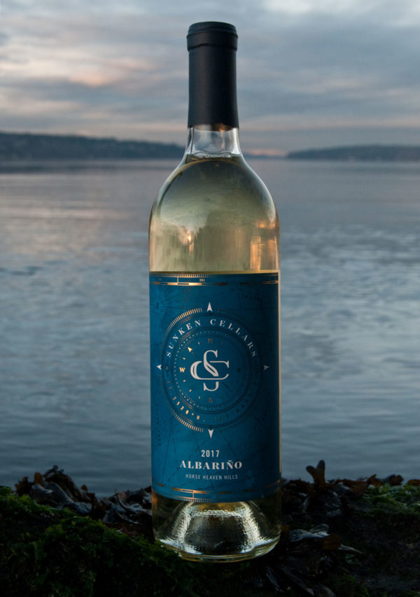Bottle of Sunken Cellar's albarino in front of the ocean