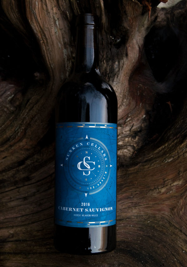 Bottle of Sunken Cellar's cabernet Sauvignon on a big log